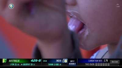 Cameraman focusing on footage of kid eating ice-cream in stands