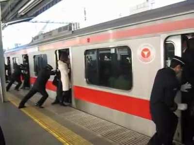 This is an actual job: Subway Passenger Pushers. It exists in Japan.