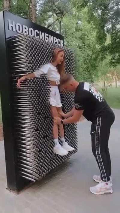 WOMAn MeRcILeSSLy puSHeD oNto WAlL oF SpikeS