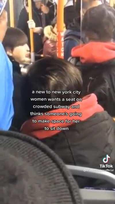 Woman demands seat on a packed train
