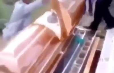 WCGW Opening a casket during a funeral