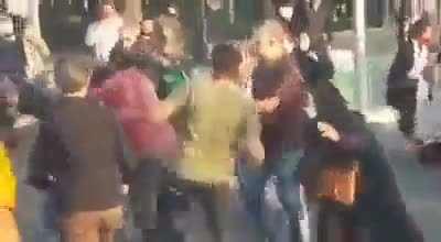 Man hits women not wearing hijab in Iran during protests other men show him the error of his ways
