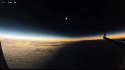 A solar eclipse happening mid-flight