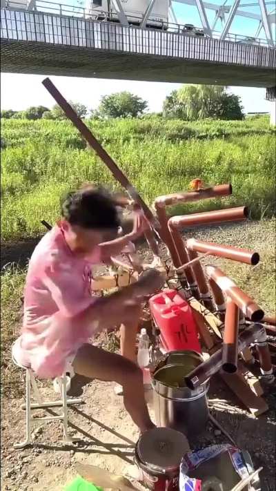 This dude goes hard with these makeshift drums