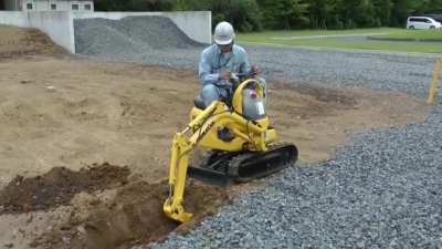 Komatsu micro shovel PC01 A very, very small excavator. It is the size of a motorcycle. It is used to dig and level the ground at very narrow sites