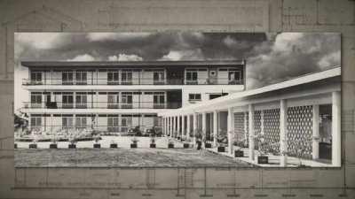 Futu Pasi aflevering 4: De Nagel Route. Futu Pasi neemt je mee langs de gebouwen van Peter Nagel. Deze architect heeft door zijn ontwerpen, gedurende 20 jaar, het gezicht van de binnenstad helpen bepalen.