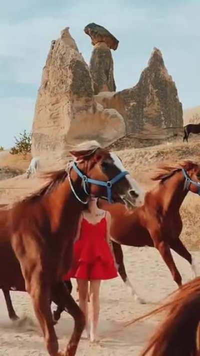 To look cool walking through running horses.