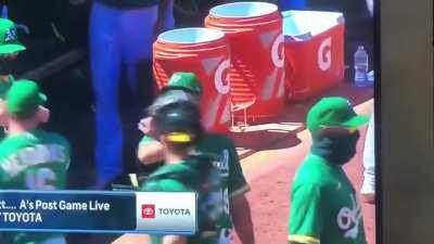 During the covid age, Oakland Athletics coach Ryan Christensen adapted a karate chop instead of elbow or fist bumps to celebrate following a win. Here, Coach was left hanging.
