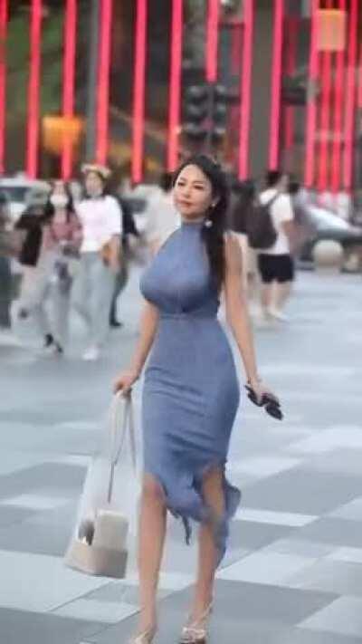 Busty beauty walking in the street