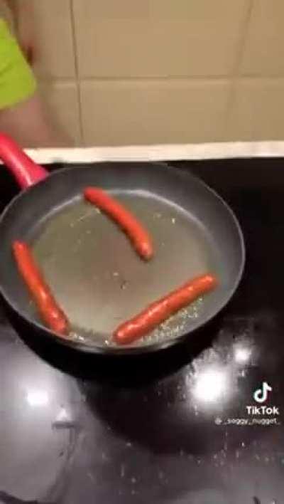 Guy dressed in marge Simpson costume cooks food