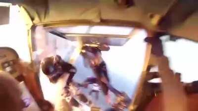 Skydivers jump from one plane to another