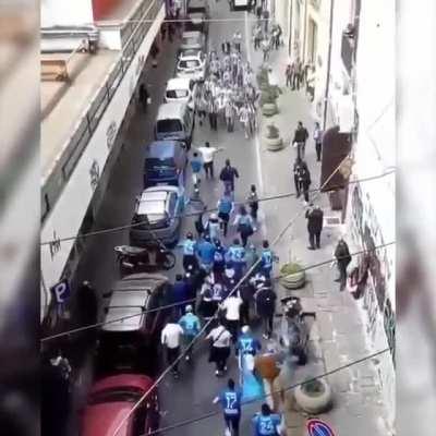 Two opposing football team fans charge at each other!