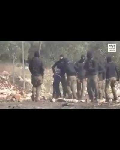 The israeli occupation forces are using a Palestinian child as a human shield.