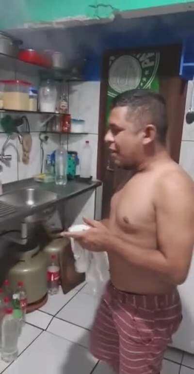 Pouring Water Into a Pot of Hot Oil