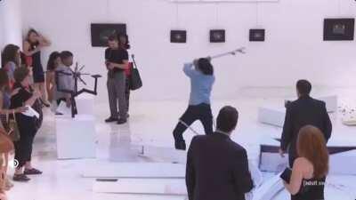 Eric Andre causing mass chaos in an art gallery.