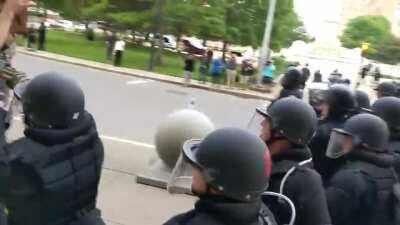 Police officers shove an elderly man in Niagara Square to the ground