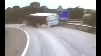 Location unknown. Van got crushed after truck flips over. No info