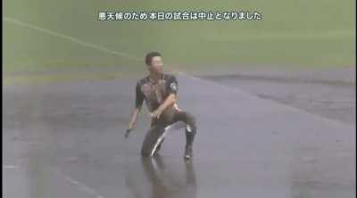 Taking advantage of a rain-out, Nippon Ham Fighter's Kenshi Sugiya runs the bases in a mudslide routine