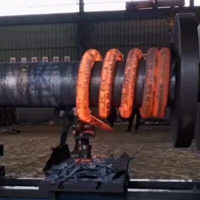 Rolling out a huge industrial steel spring