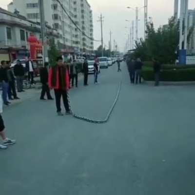 Guy Whipping a Massive Chain