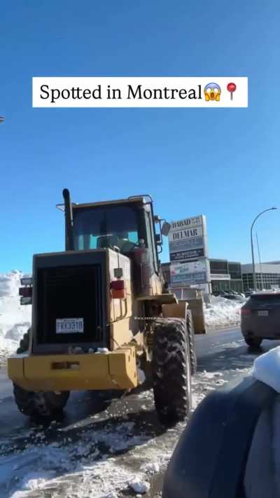 A front end loader and SUV get into it in Montreal.