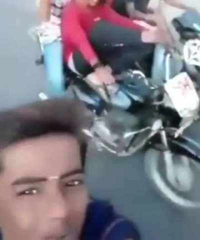 filming a video while riding motorcycles. plus legs on handle