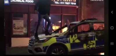 Posing on a burnt out police car for the insta