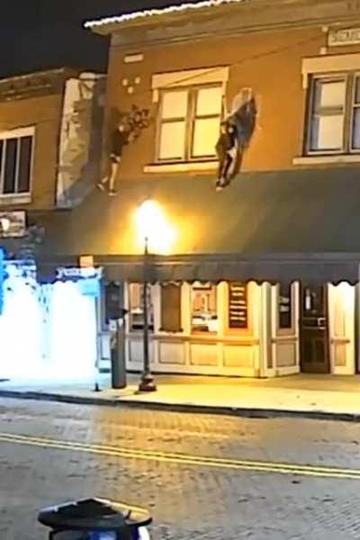 WCGW standing on a canopy to graffiti a building