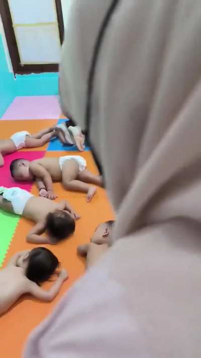 There's a a child daycare in Indonesia, where babies are tied up throughout the day