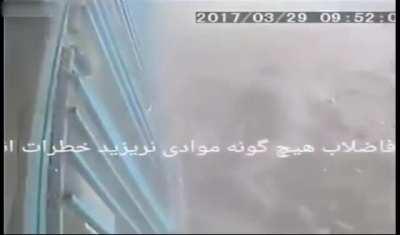 Guy drops cigarette in sewer hole