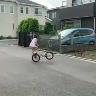 Little girl perform BMX stunts