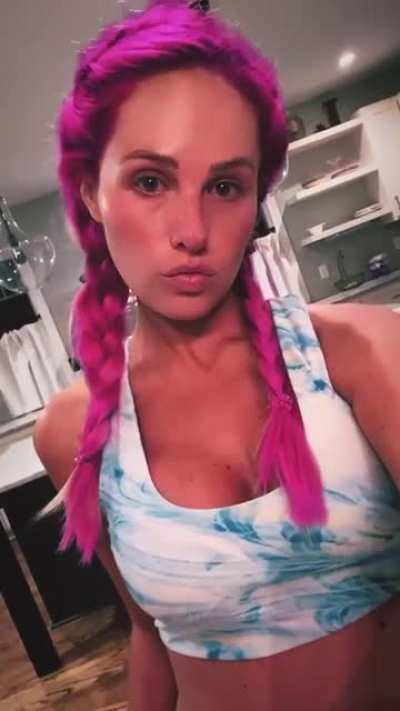 Tomi IG story with hot pink hair and cleavage