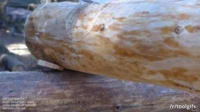 How a log cabin builder achieves the tightest fit using a log scribing tool