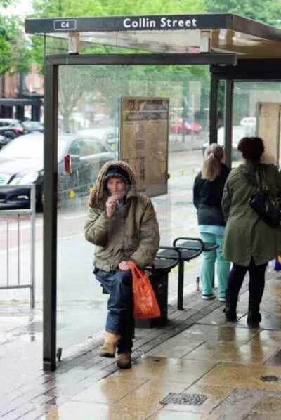 POV: You are waiting at a bus stop in the rain when a car blasting 