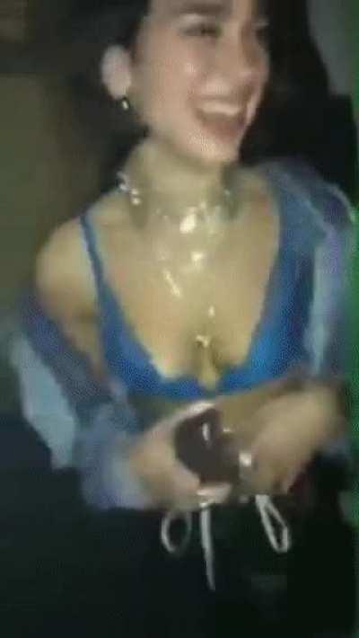 Playing with her breasts on a night out