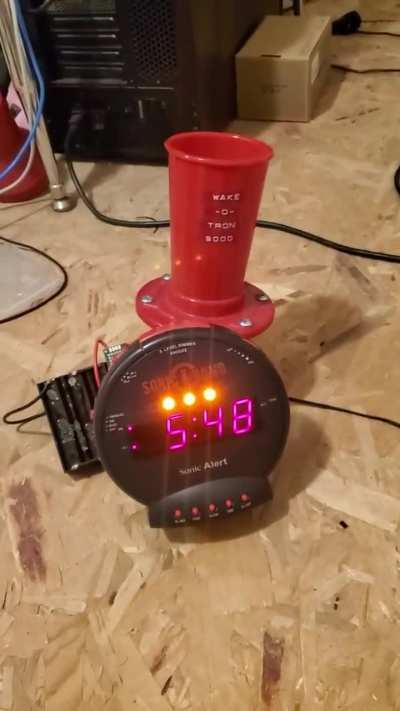 (SOUND WARNING) I'm a heavy sleeper. After rigging a TENS unit to my alarm clock failed (I couldn't get to sleep with electrodes on me), I decided to instead rig a harbor freight klaxon alarm to it. Now it bottoms out my hearing. Dive! Dive!