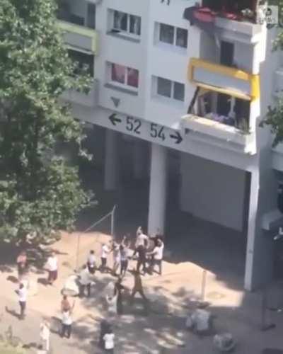 Group of people savagely throw a 3 year old and 10 year old into a burning building