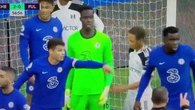 Chelsea vs Fulham (1st May). Bobby Reid trying to undo the gloves of Mendy during a corner kick to distract him(?)