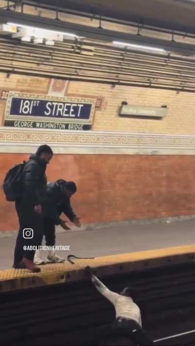 Fellow New Yorkers help a man up onto the platform