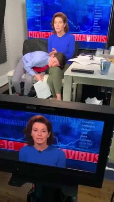 MSNBC anchor Stephanie Ruhle reports live on air with her son hiding on her lap