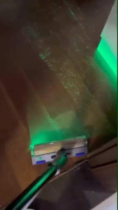Vacuum has laser to reveal floor particles