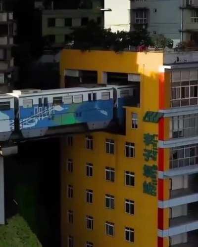 A train that runs through residential apartments in China.