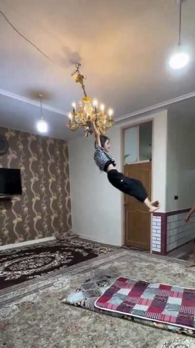 Not just allowing, but encouraging his kid to swing from a lit chandelier...