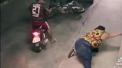 Morbidly obese woman tries sit on the back of a motorcycle.