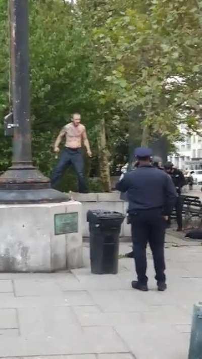 Shirtless dude with DIY wolverine claws has a stand off with NYPD in a park.