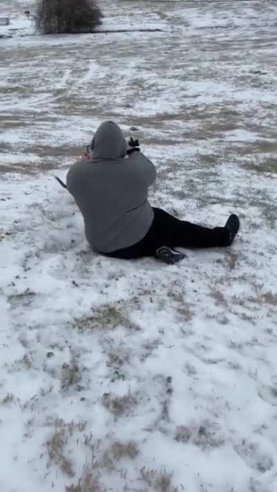 Dog gets excited about the snow and pulls guy down the hill
