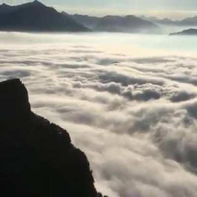 Hang gliding above the cloud