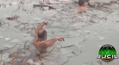 Police officers saving a dog from a frozen lake in Huesca, Spain.