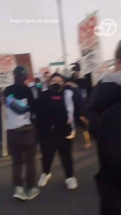 ICE Secret Police shoots a priest point blank in the mouth with a 40mm tear gas grenade during a protest near the USCG Base in Alameda, CA (in the Bay Area of CA)