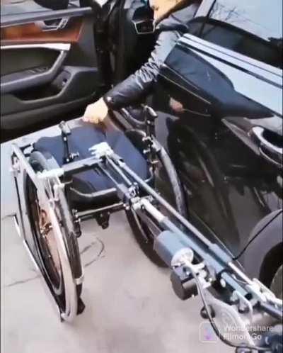 This car has a custom machine arm to put away the wheel chair